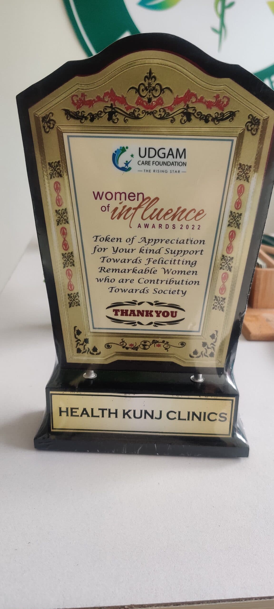 Token of Appreciation trophy presented to HealthKunj Clinics at the Women of Influence Awards 2022